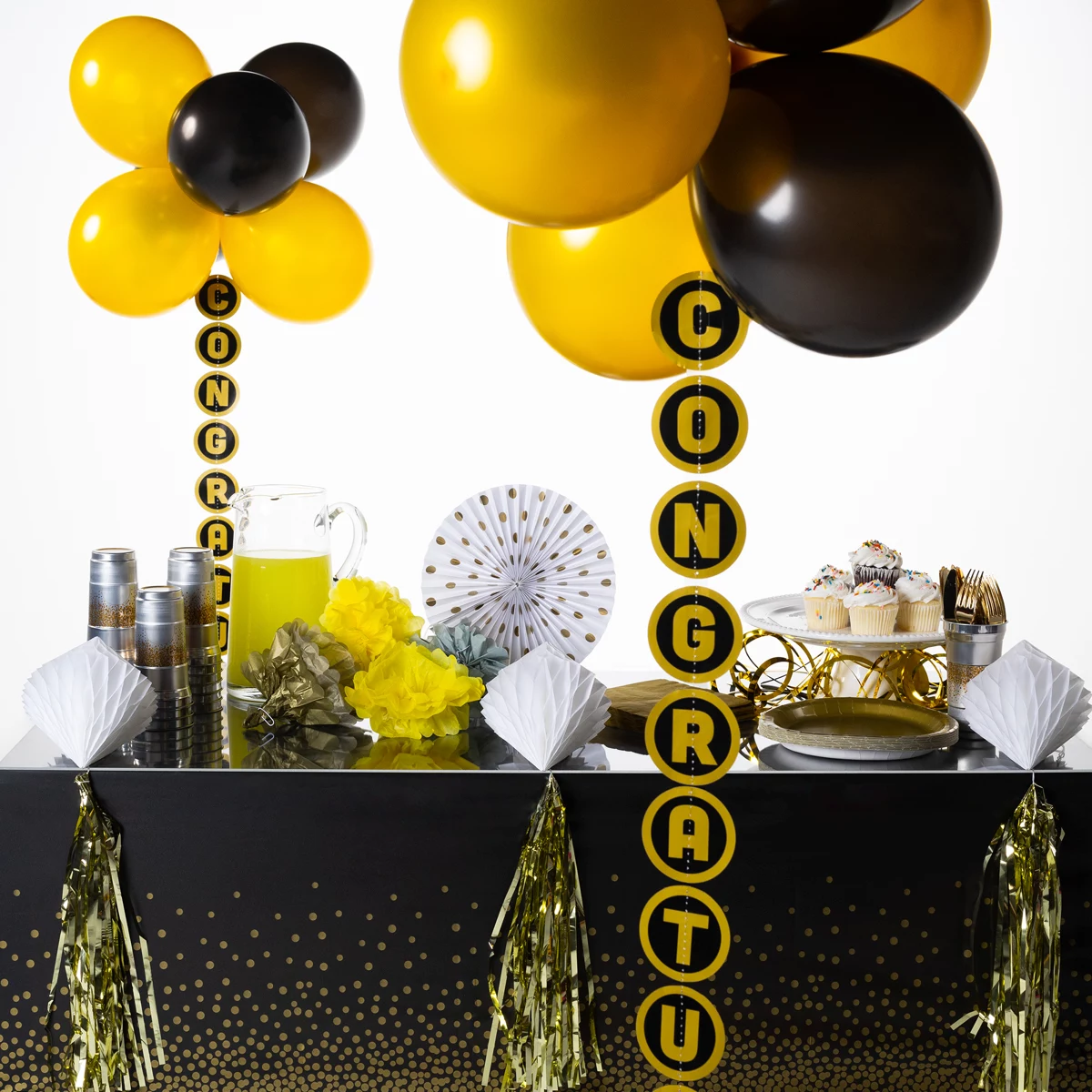 Black and gold party table with Congratulations balloon tail display