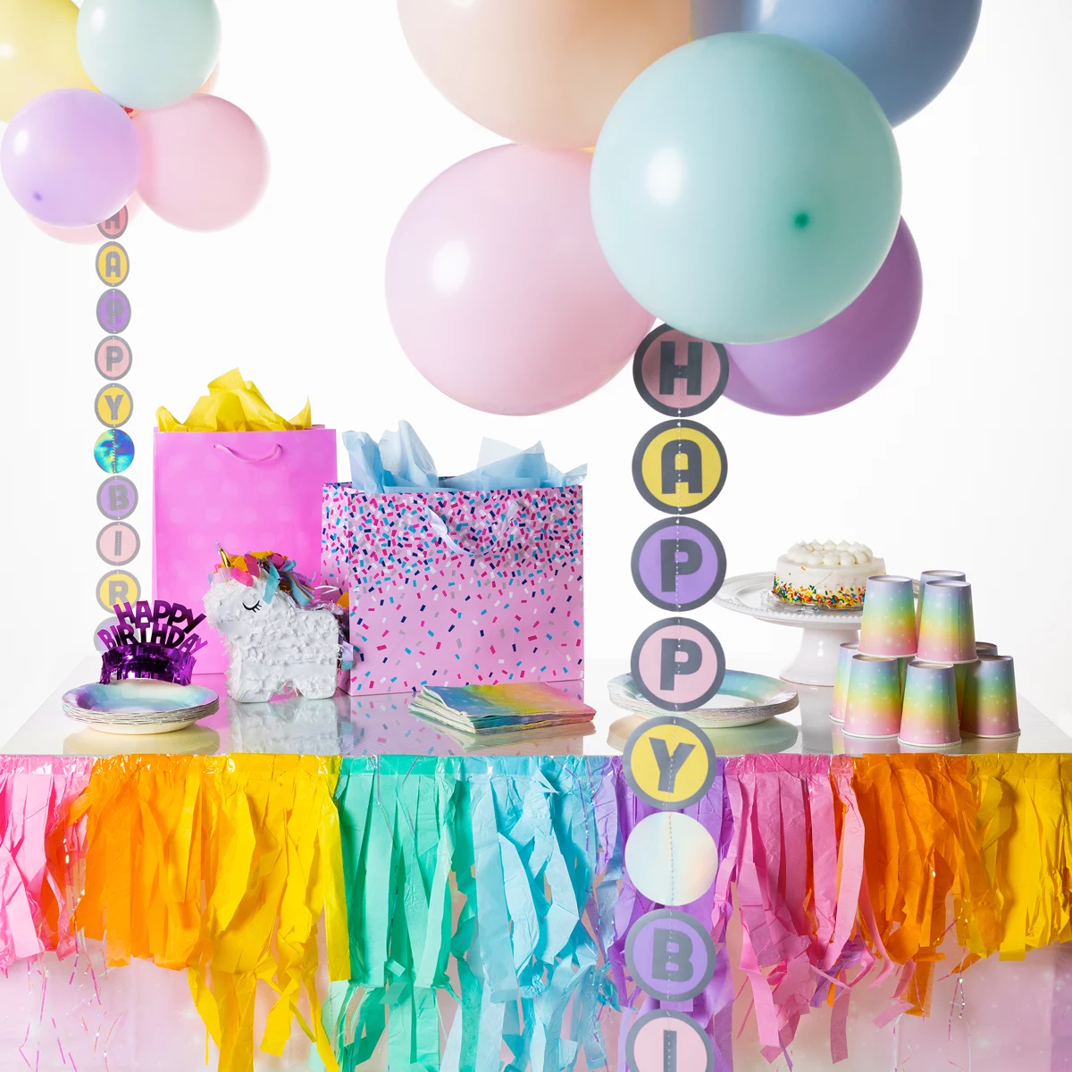 Pastel themed party table with Happy Birthday balloon tail display