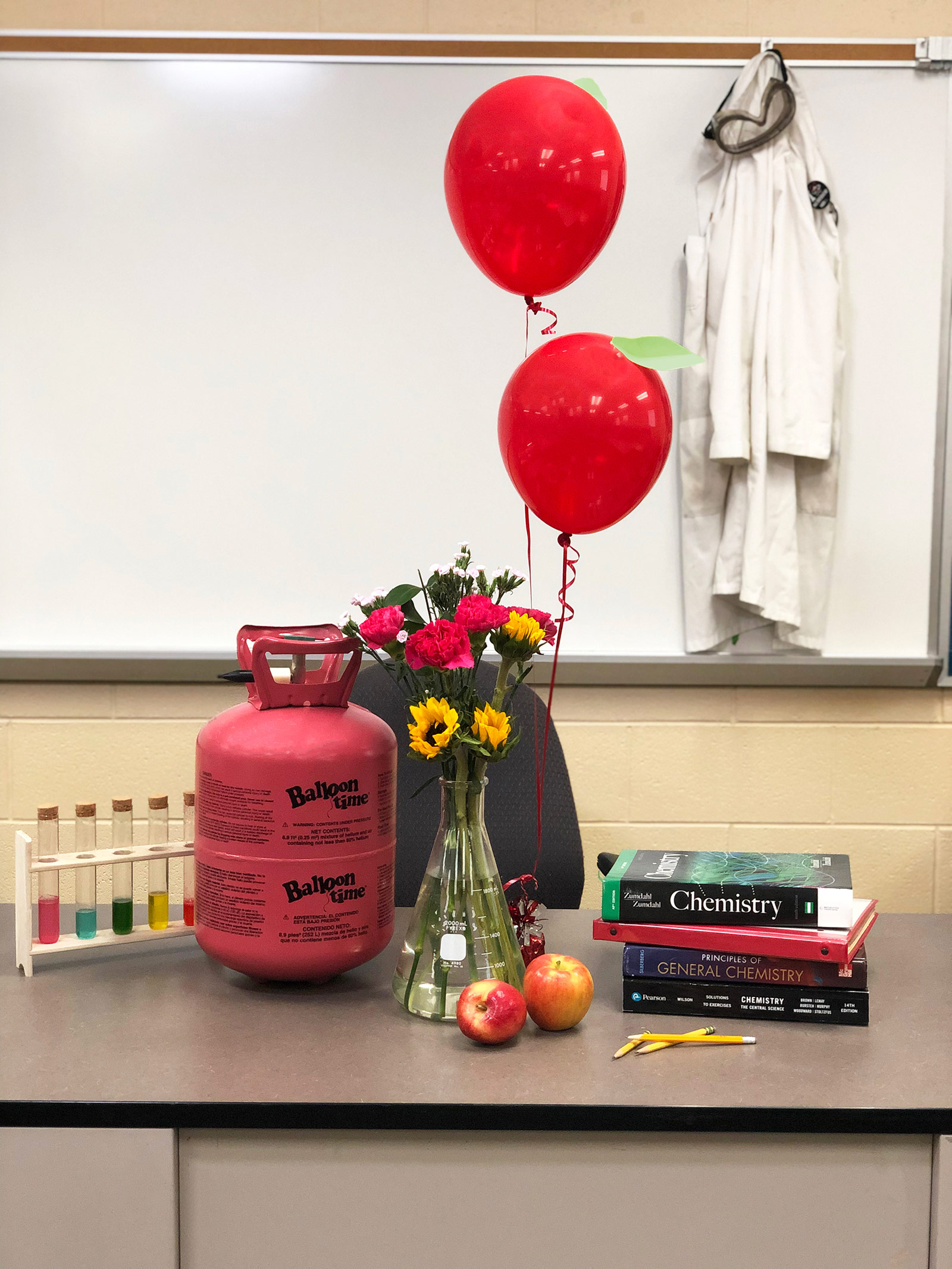 Balloons and helium tank in classroom