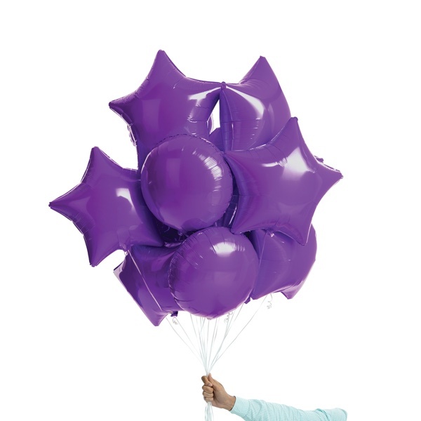 Hand holding purple foil balloons