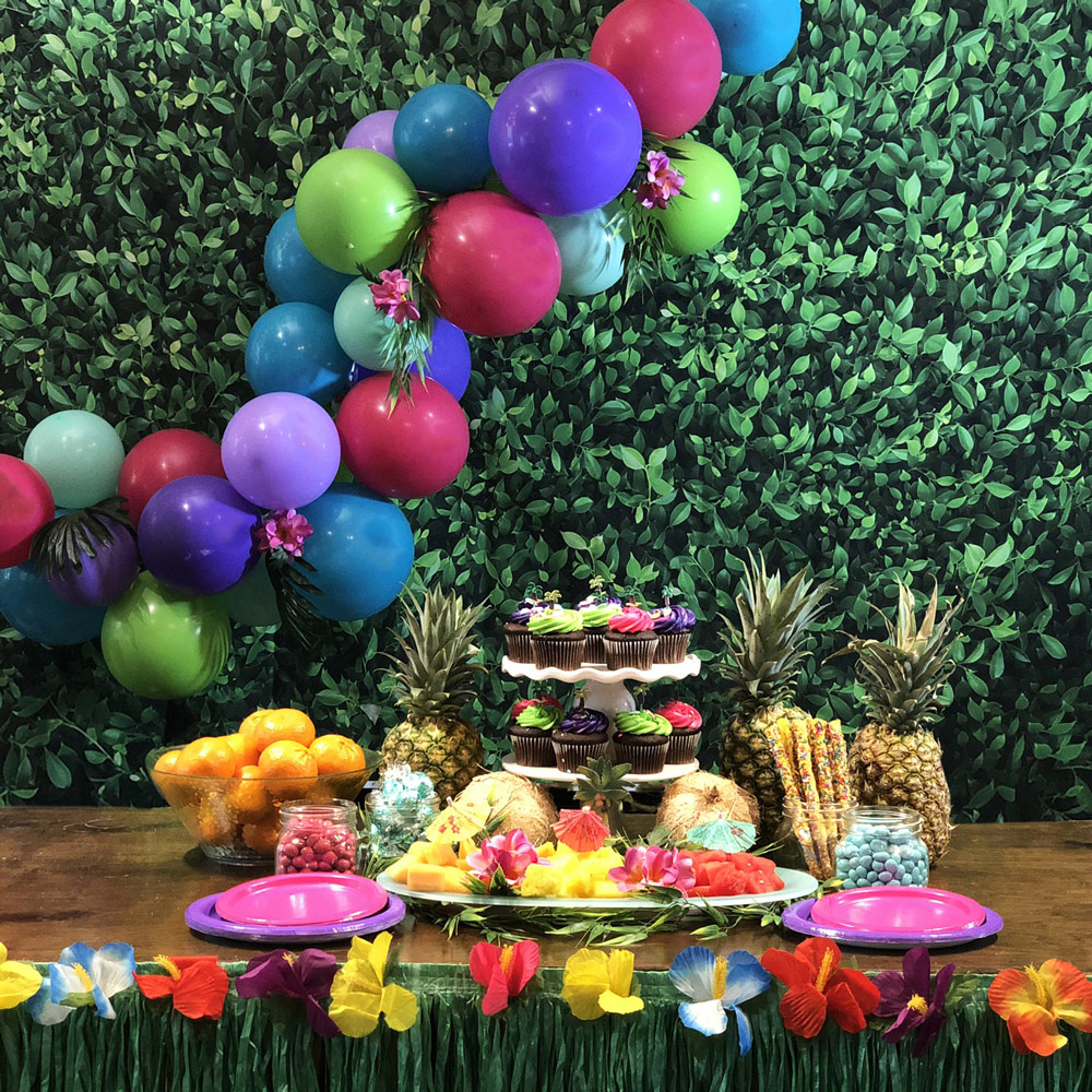 Hawaiian dessert display with balloon garland