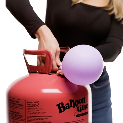 Woman filling latex balloon with Balloon Time jumbo tank